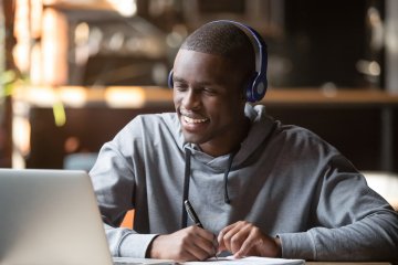 Student with headphones and laptop