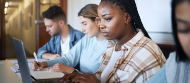 Teenagers sitting at computers.