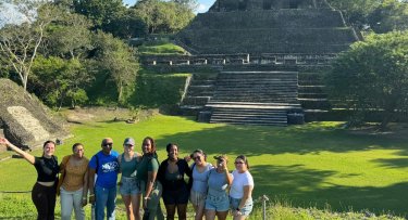 Mercy University students in front of a pyramid in Belize