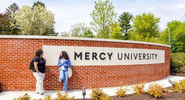 Mercy University Westchester Campus entrance with 2 students in front