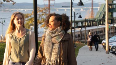 Diverse students walking to campus together.