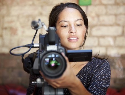 Film student behind camera.