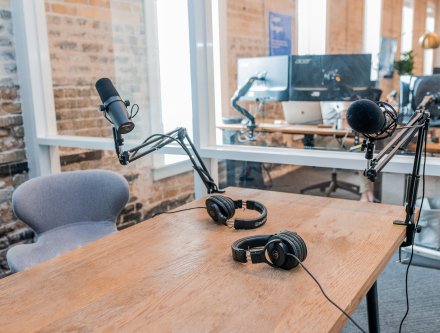 Image shows a recording studio with microphones.