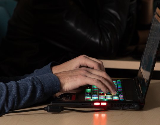 Cybersecurity student at work on computer.