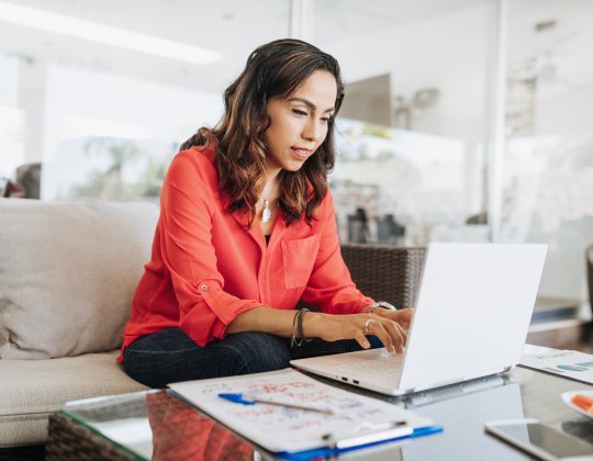 Woman at home with laptop