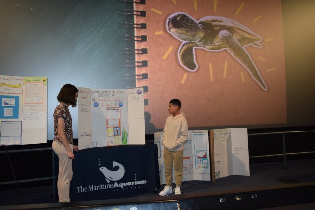 A student from Long Island Sound Schools Network presents his work at the Maritime Aquarium